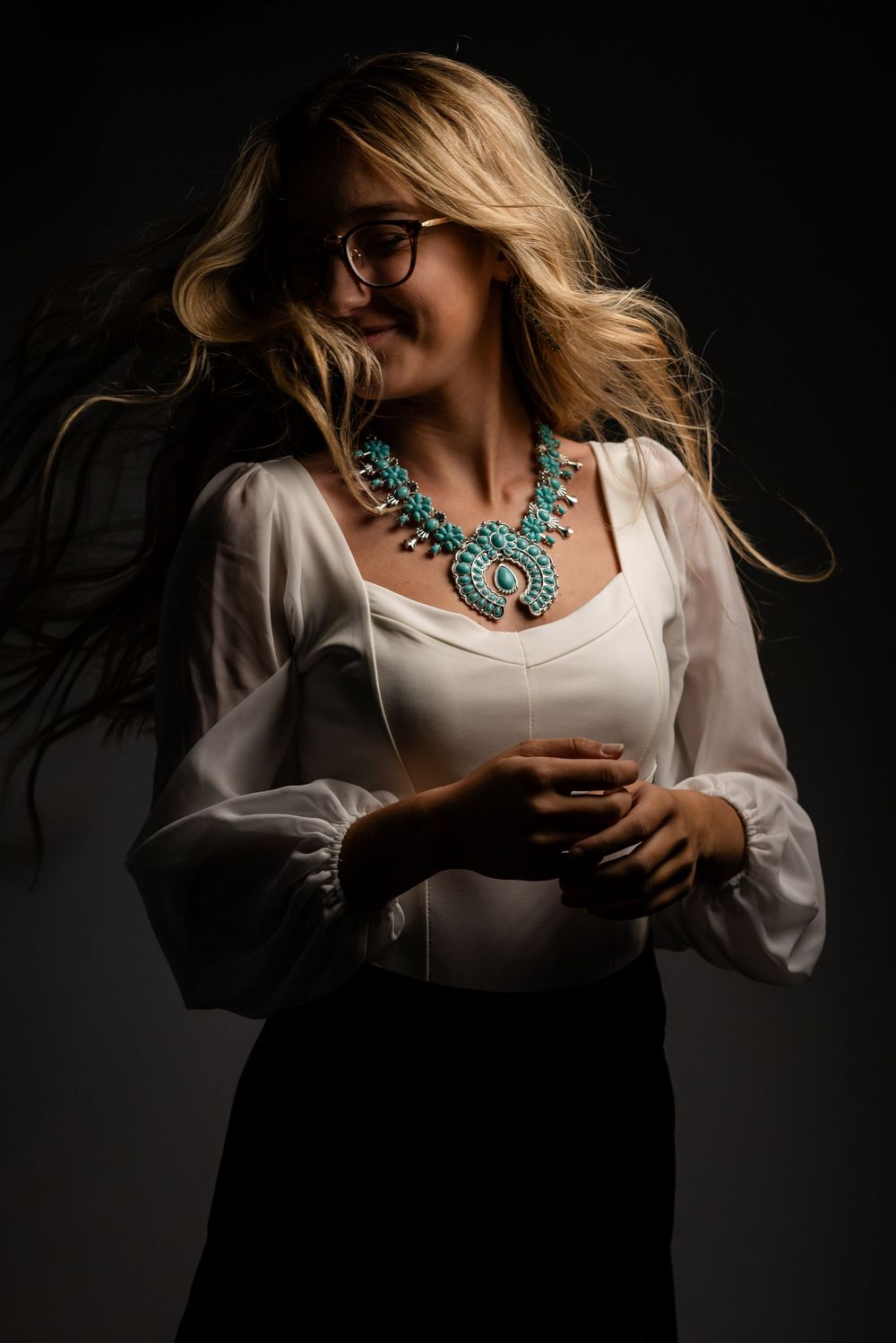 Fine art portrait of a young woman in dramatic studio lighting in Mountain Home, Arkansas