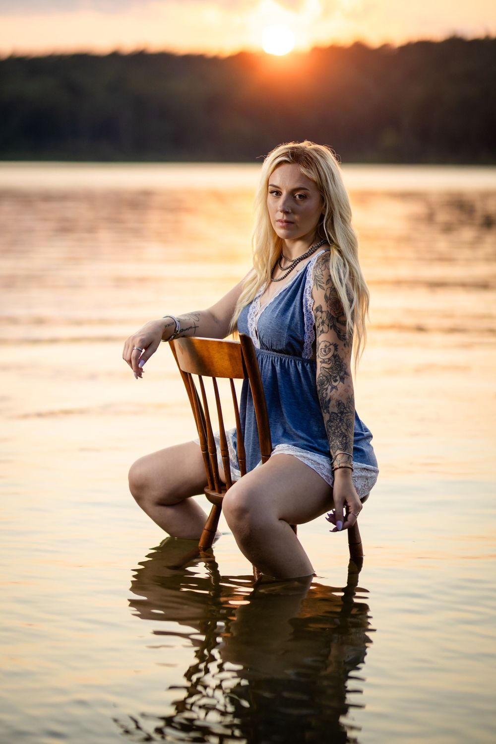 Fine art portrait of a woman on a chair in the water at sunset at Norfork Lake in Henderson, Arkansas
