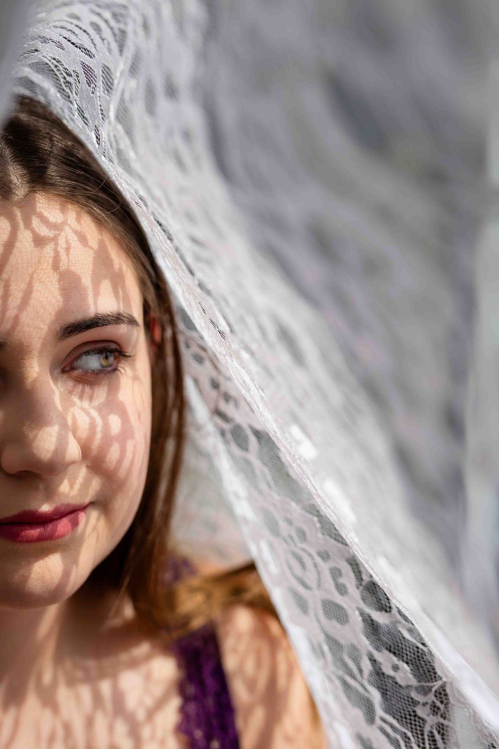 Moody fine art portrait of a young woman with a lace veil during a studio session in Mountain Home, Arkansas