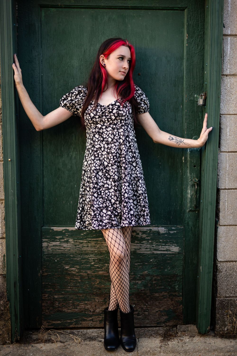 Creative individual portrait of a young woman by a green door in downtown Mountain Home, Arkansas