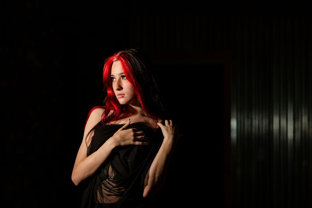 Dramatic creative portrait of a young woman during an individual session in downtown Mountain Home, Arkansas