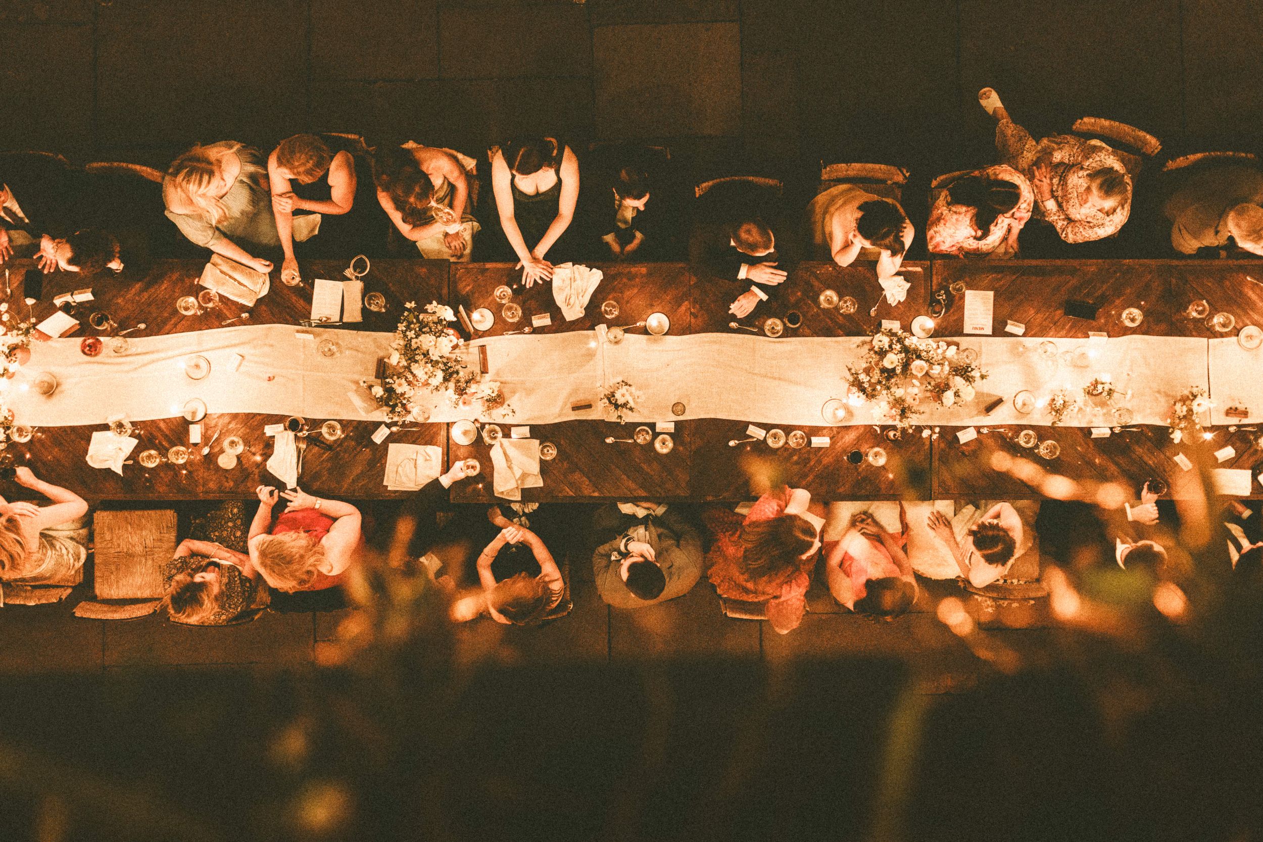 Glowing bokeh lights create a warm and magical atmosphere in a dark setting.