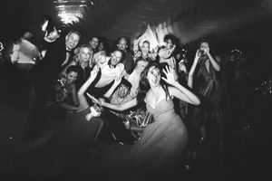 Black and white photos show people dancing and celebrating at a lively party or nightclub event.