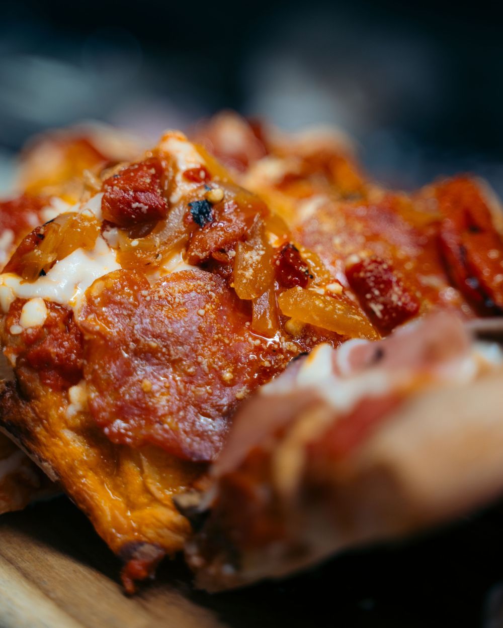 Close-up of cheesy pepperoni pizza slice with golden crust on wooden board.

Vancouver Canada Scene