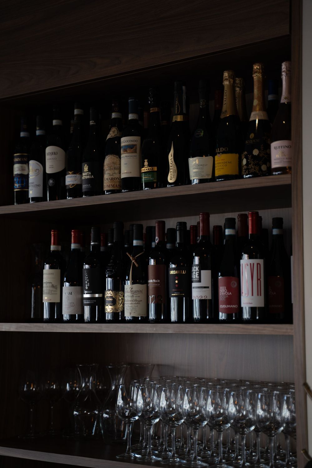 Dark wooden shelves stocked with wine bottles and sparkling glasses in restaurant bar.

Vancouver Canada Scene