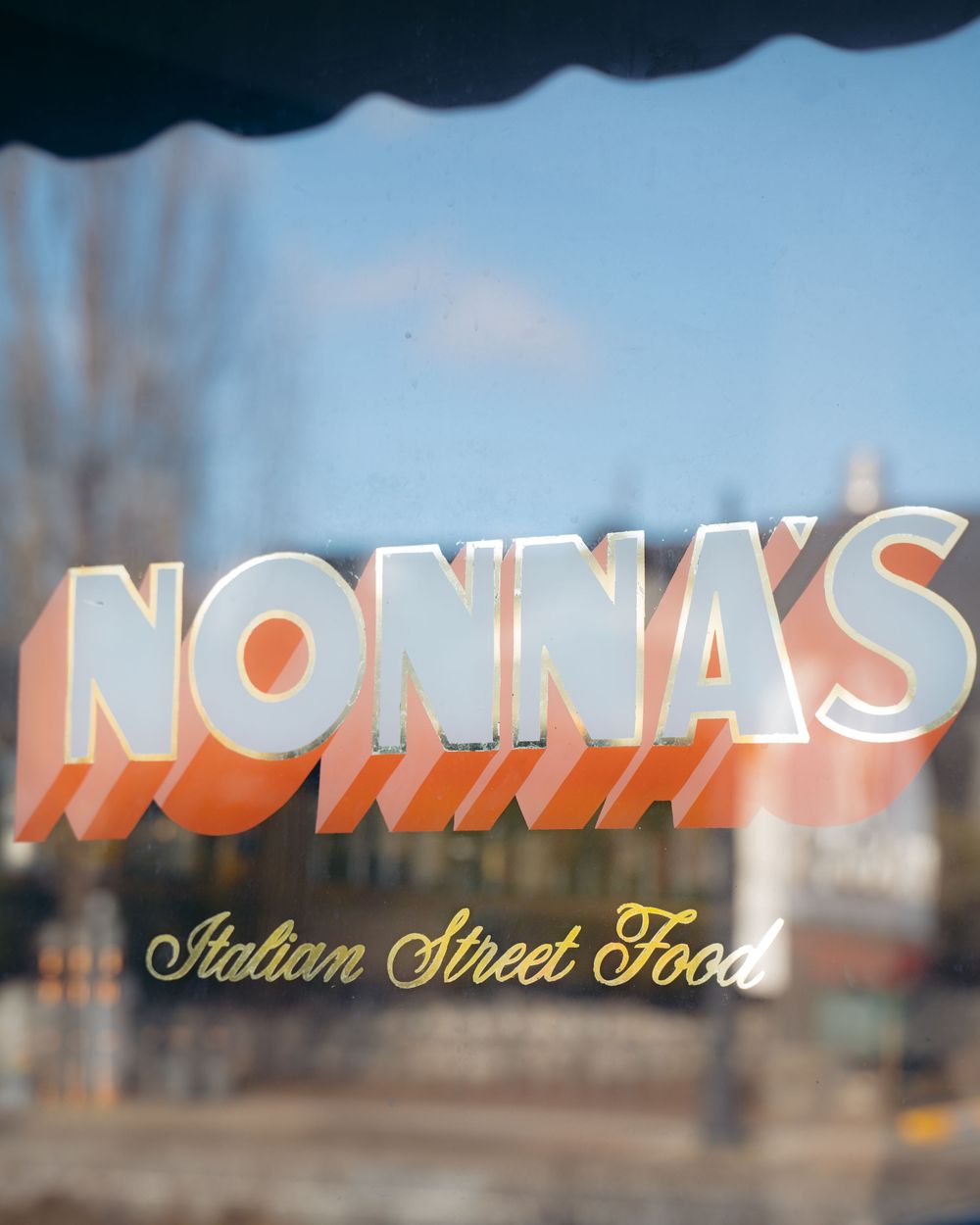 Nonna's Italian Street Food restaurant logo on storefront window with outdoor reflection.

Vancouver Canada Scene