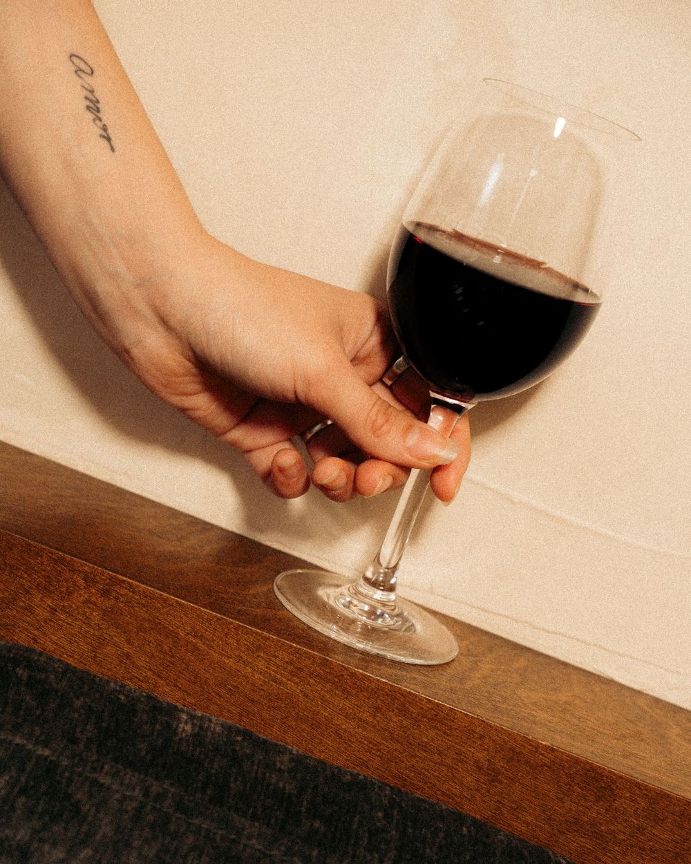 Tattooed hand holding a glass of red wine against neutral background.

Vancouver Canada Scene