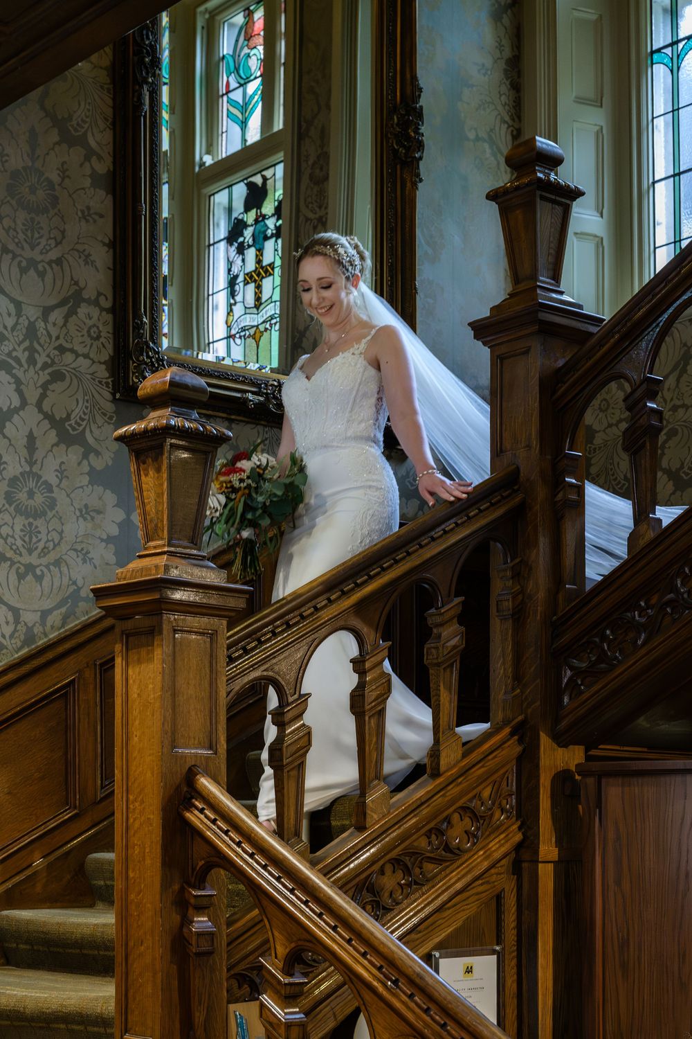 Bride coming down main staircase at Merewood Country House Hotel