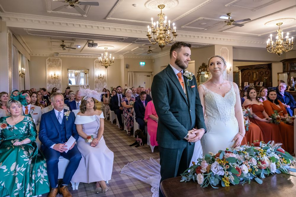 Bride and groom with guests behind them at Merewood Country House wedding