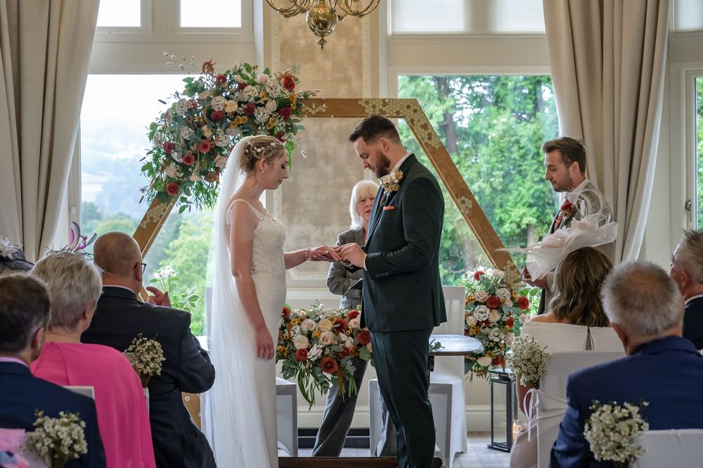 Couple exchanging rings at Merewood Country House wedding