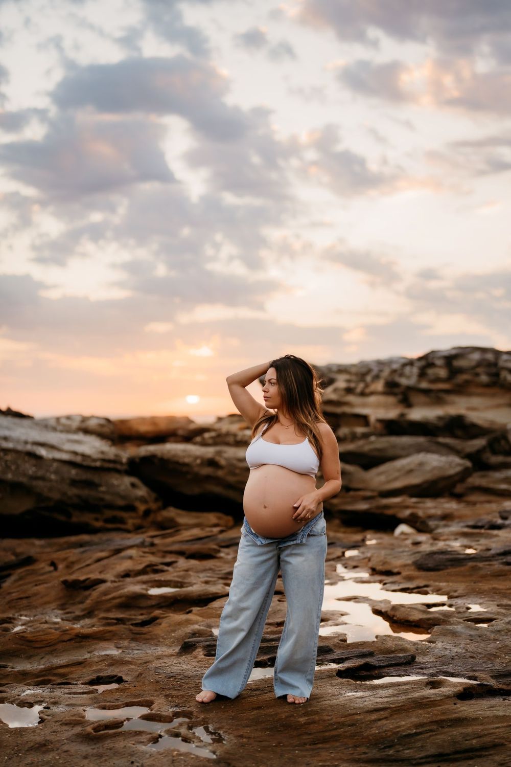 Natural maternity photography showing a pregnant mum wearing jeans