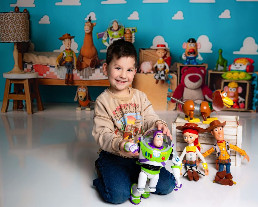 Toy Story collection displayed with Buzz Lightyear and Woody figures arranged on wooden furniture against turquoise wall.