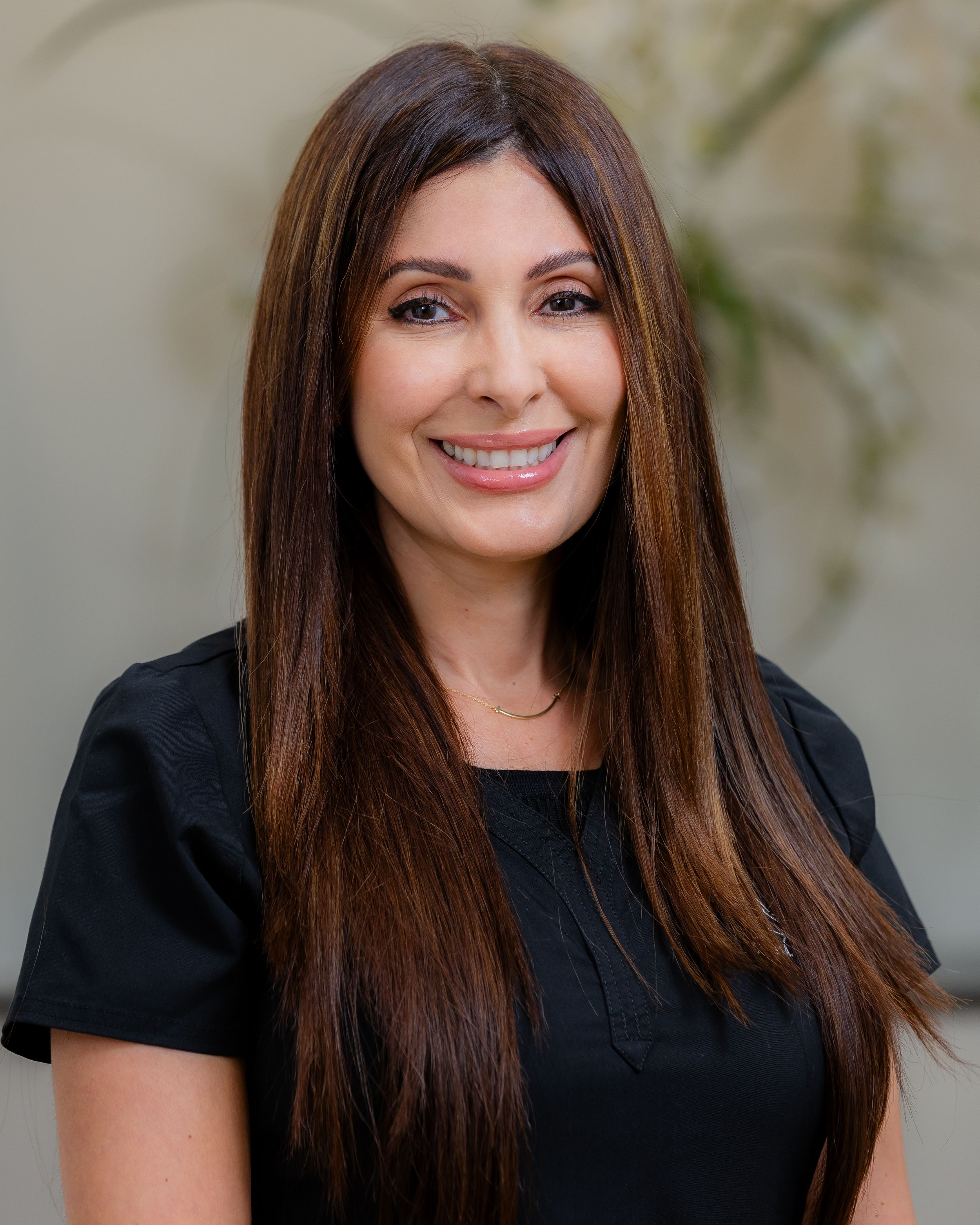 Professional headshot series featuring someone with long brown hair wearing a black shirt against a neutral background.