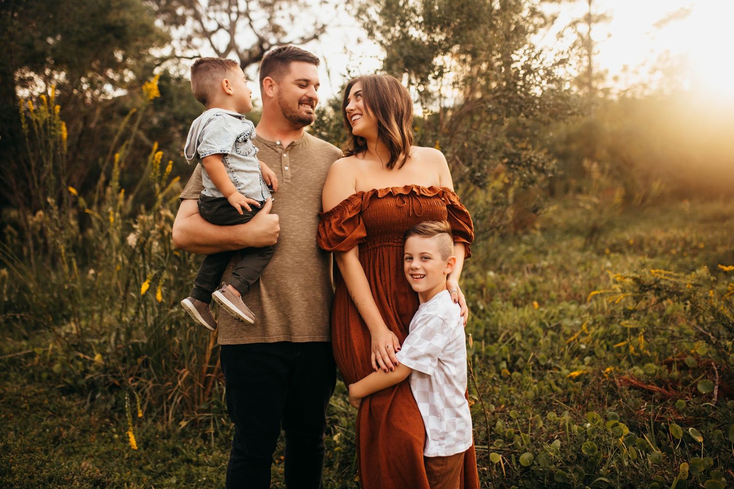 family of four wandering through the beautiul parks in largo FL loving on each other