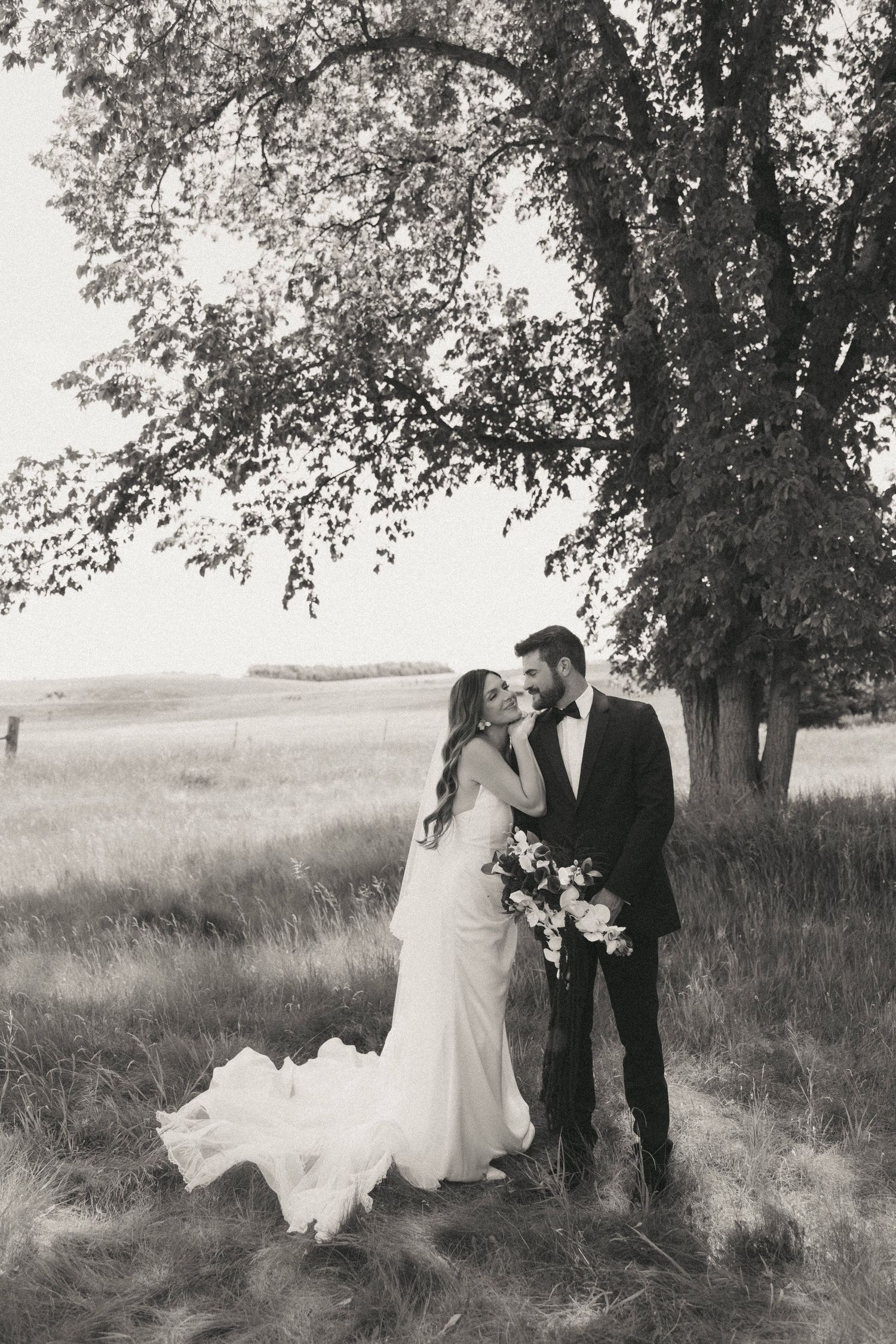 Couple sharing a romantic moment with yellow floral decorations in the background.