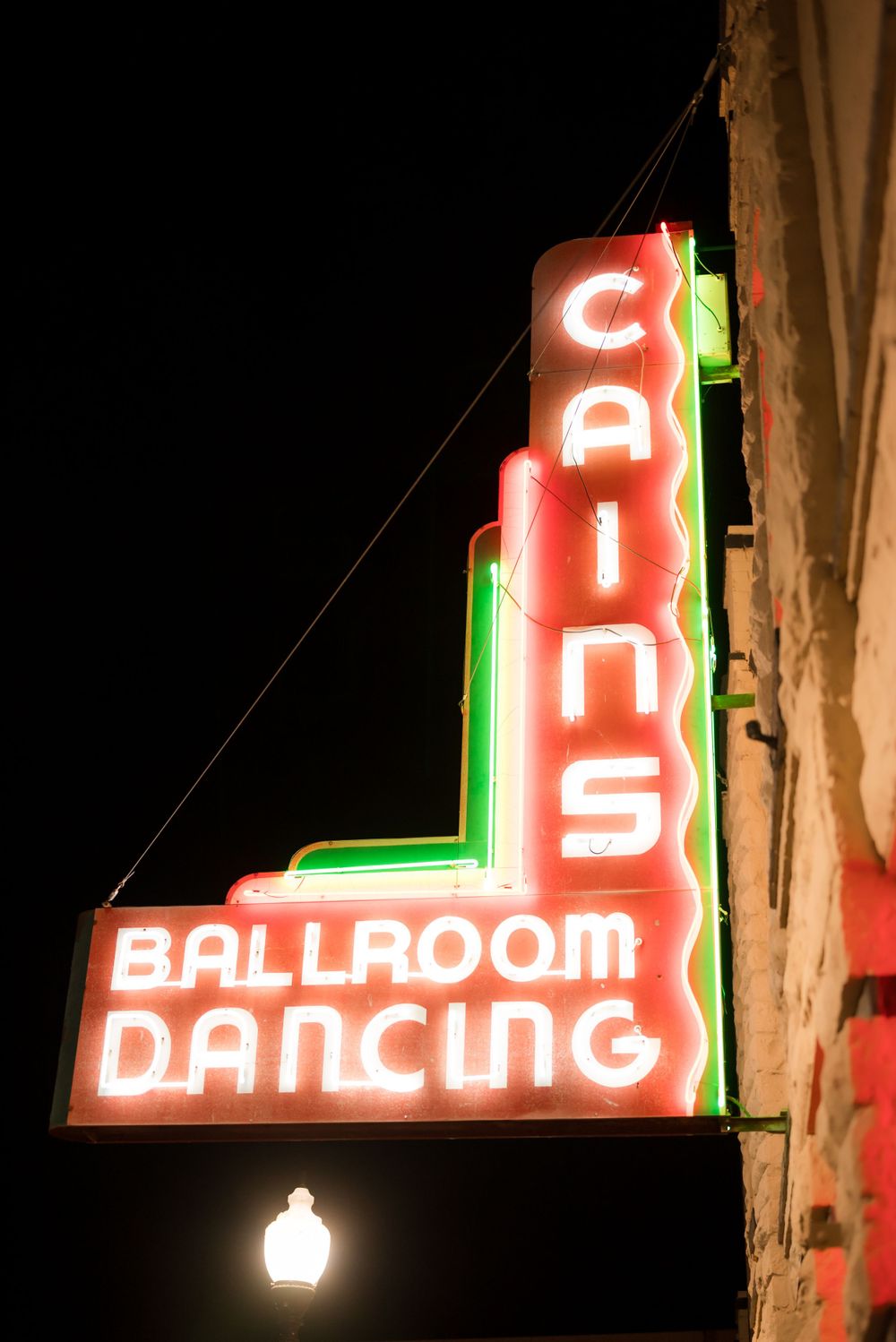 Retro neon sign for Cain's Ballroom Dancing with red and green lighting.