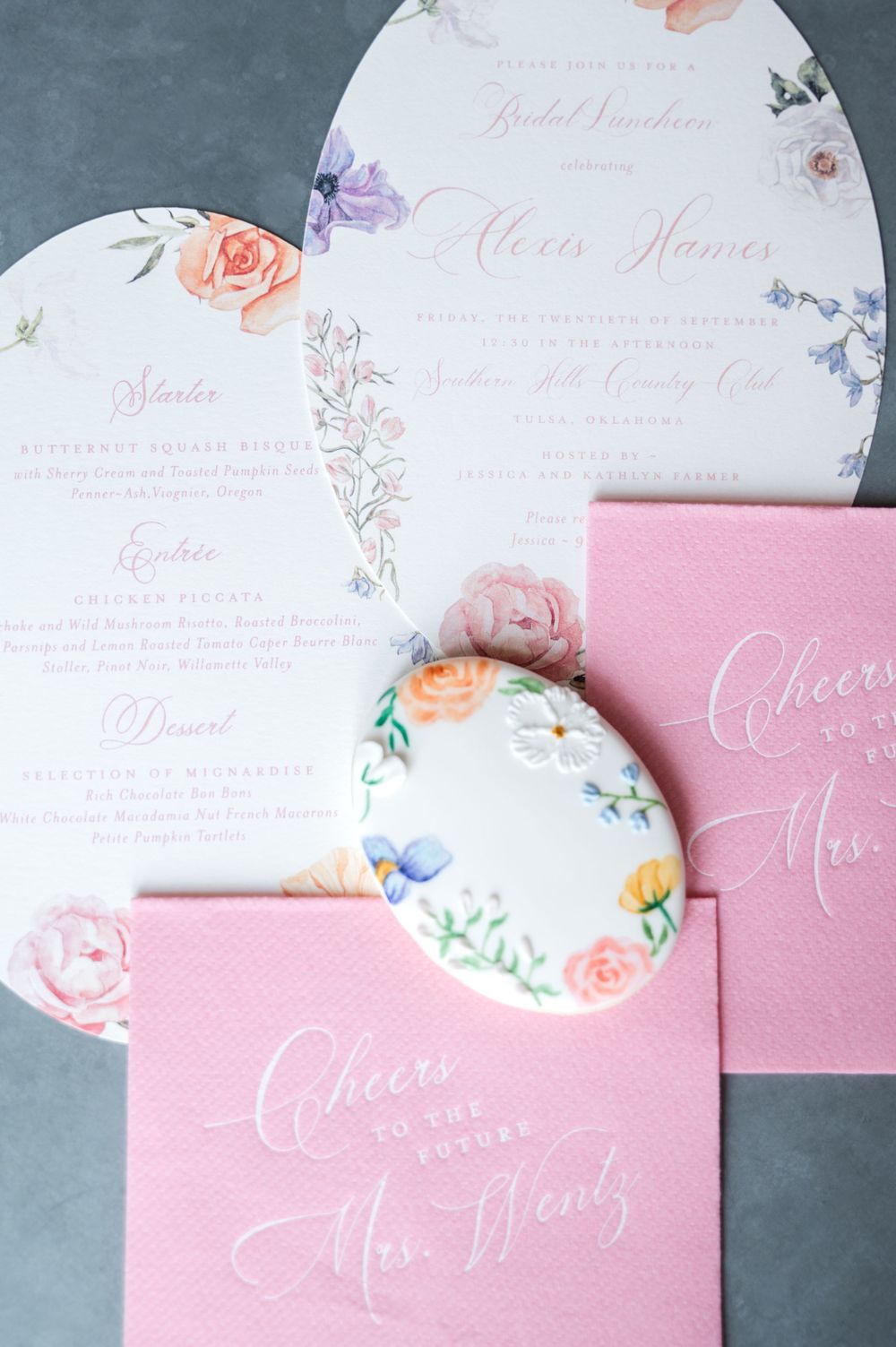 Pink and white wedding stationery suite featuring floral designs and calligraphy.