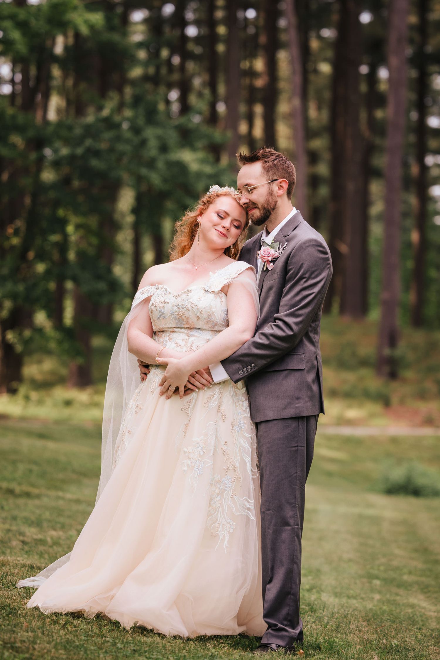 Groom resting his forehead against the bride's as she closes her eyes in a quiet embrace.