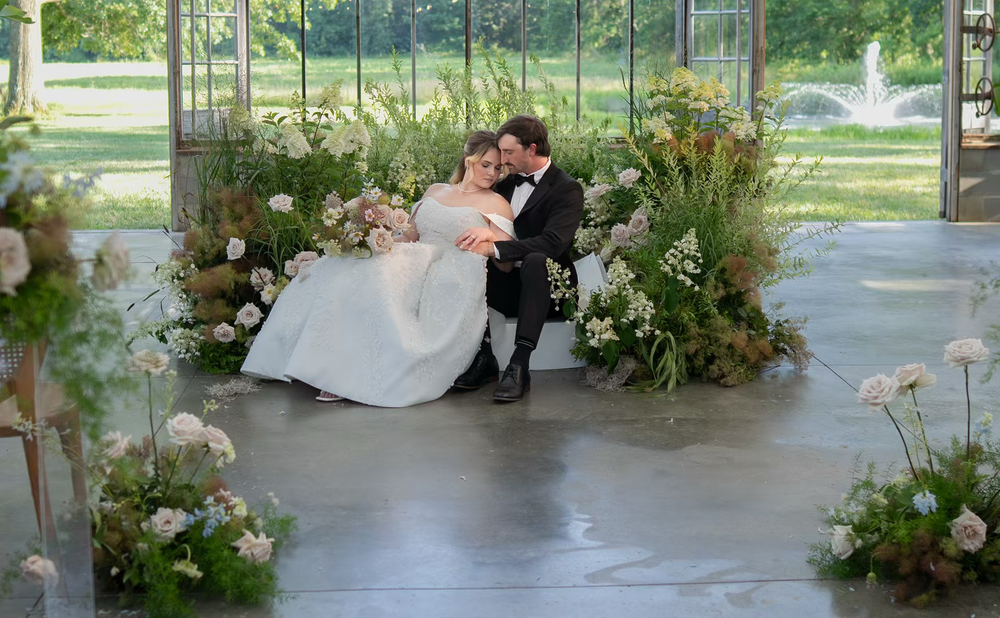 elegant Bride and groom share a romantic kiss in  a luxury  greenhouse wedding venue Jorgensen farms.