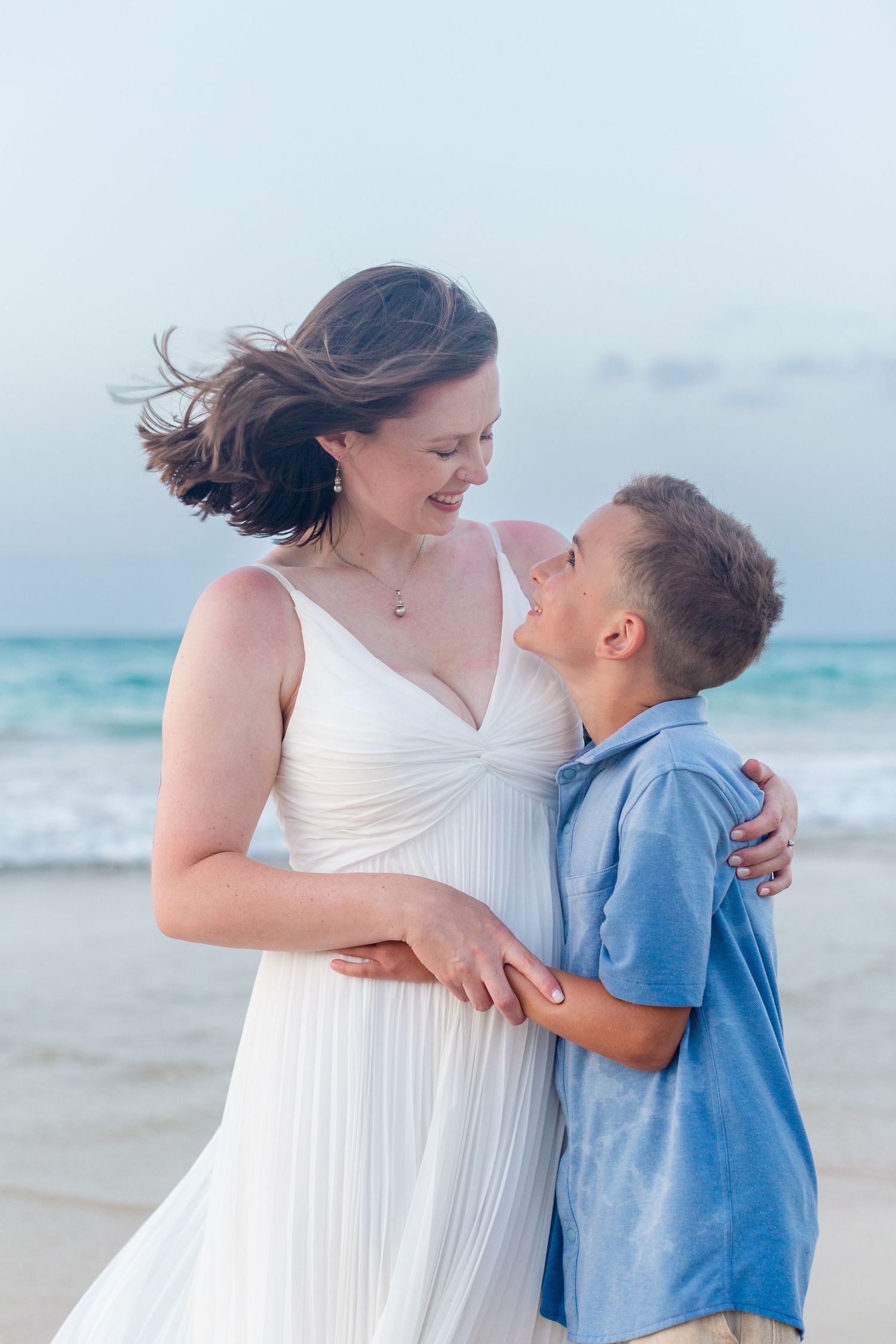 Family portrait on the beach in Isla Verde, Carolina, Puerto Rico. Mother and son.