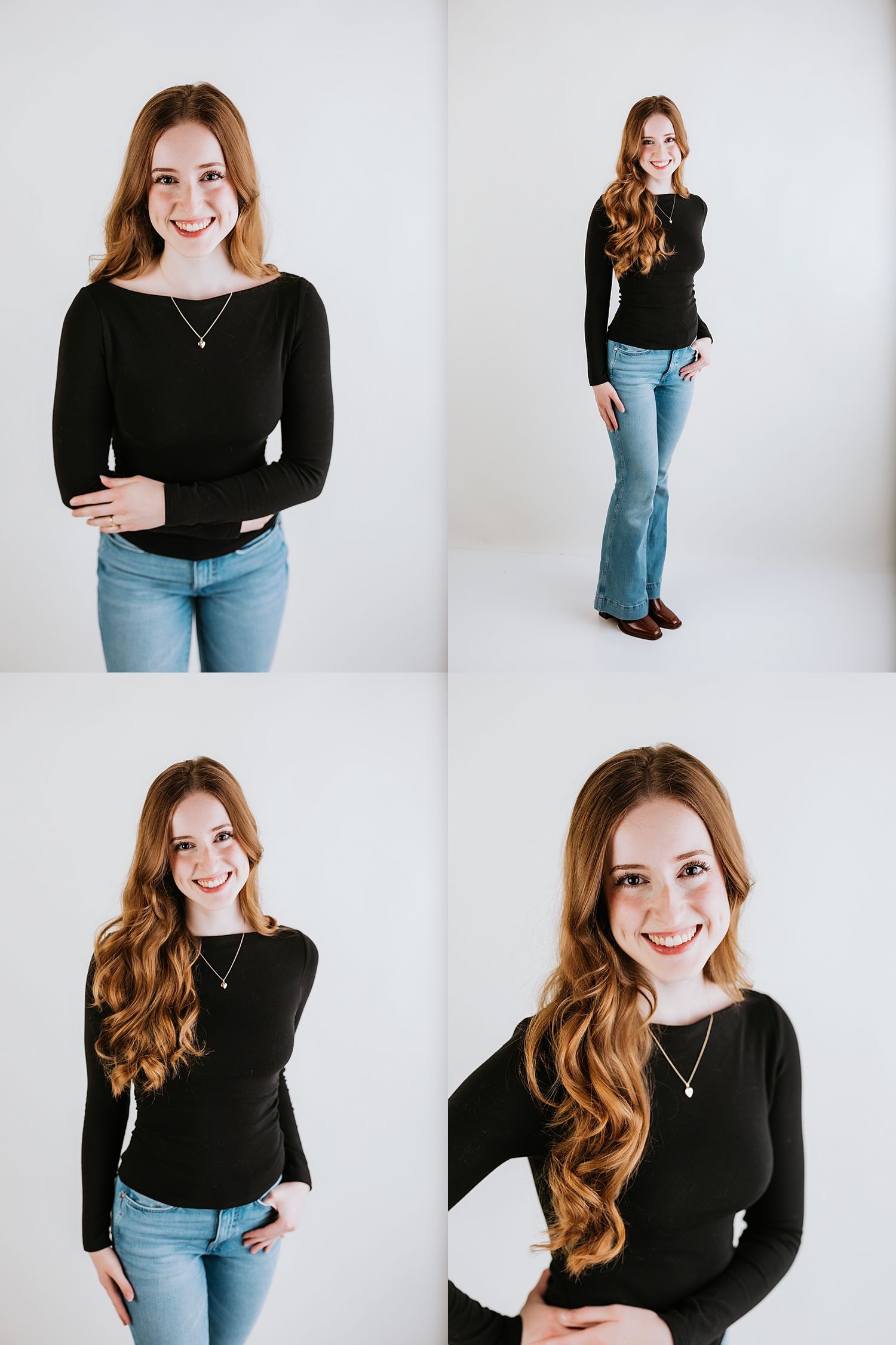 Young woman with long auburn hair wearing a black long-sleeve top and blue jeans, smiling in a white studio.