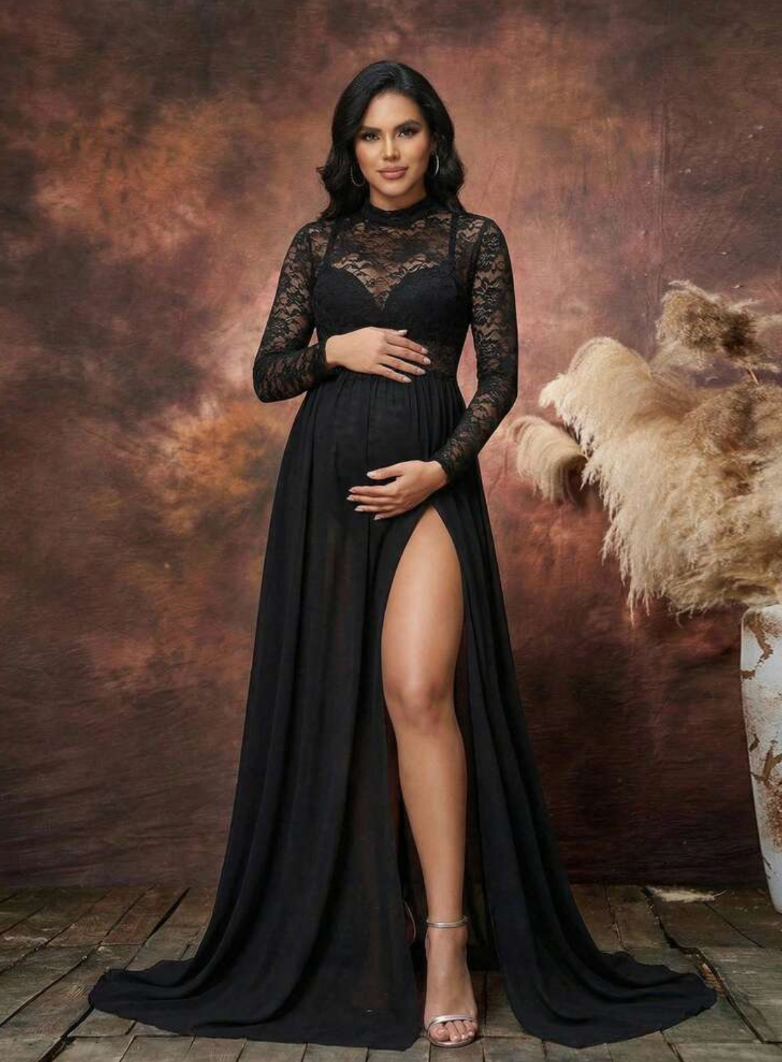 Pregnant woman in elegant black lace and chiffon maternity gown with high slit and long sleeves.