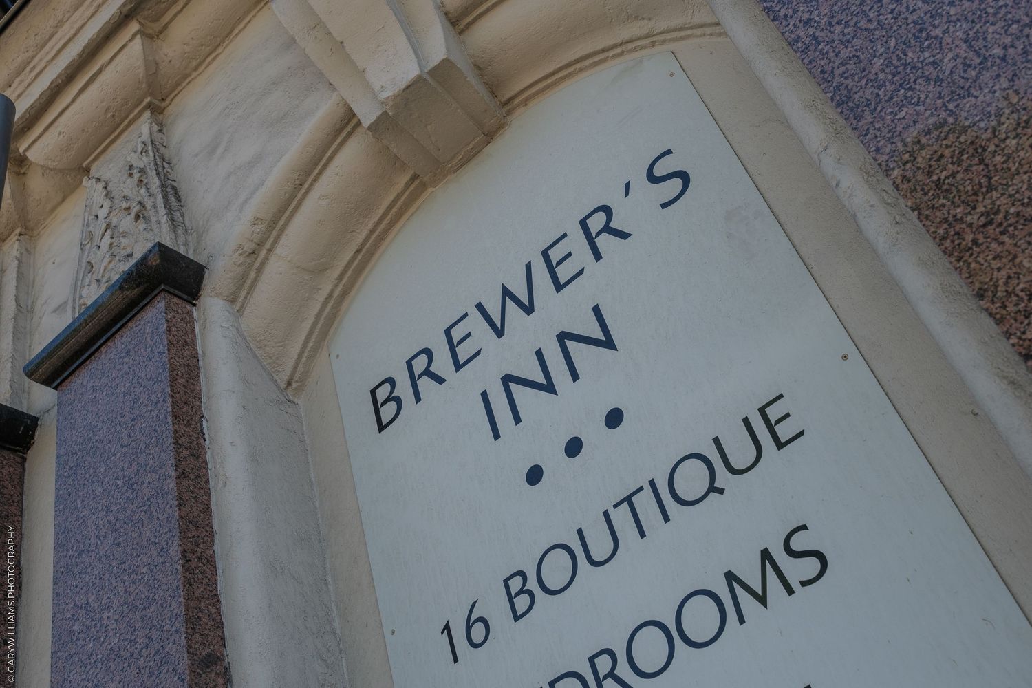 Sign for Brewer's Inn, a 3-star boutique hotel with 16 rooms, displayed on a classic stone building facade.