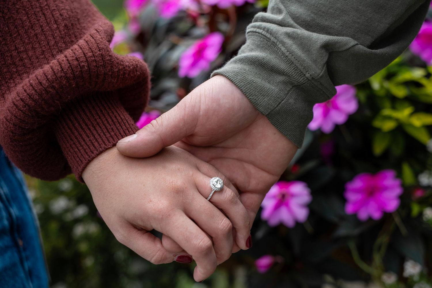 Engagement ring in front of beautiful flowers