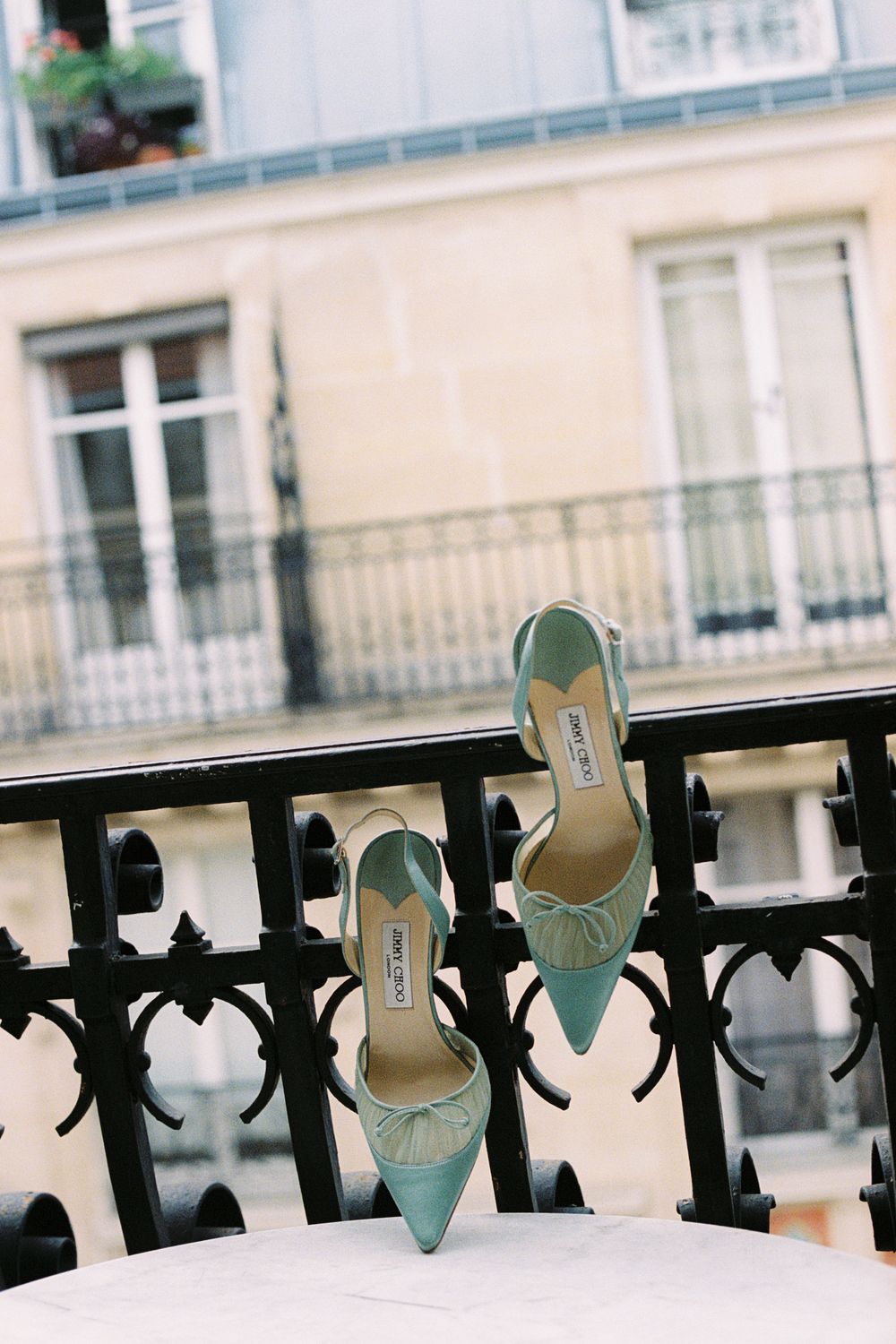 Mint green Jimmy Choo heels displayed on a Parisian balcony, vintage jimmy choo, paris wedding, paris film photographer, paris