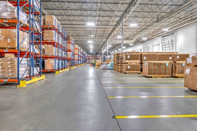 Interior of a large commercial warehouse with pallet racks and storage areas in Lumberton NC
