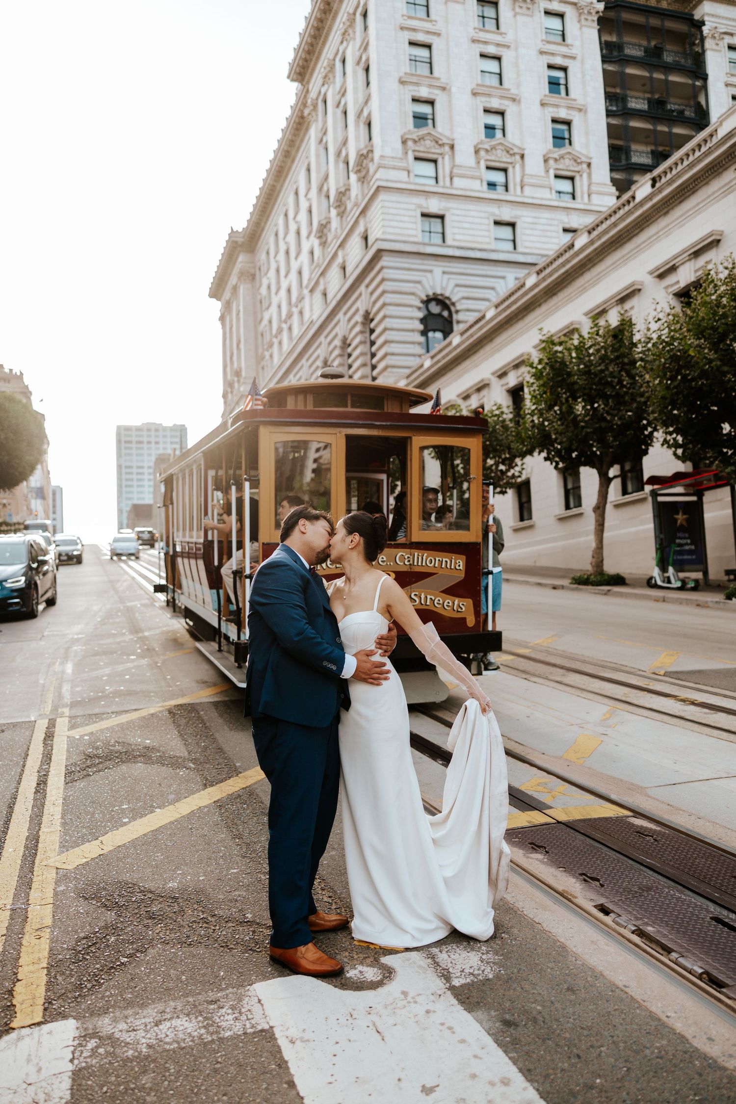 romantic couple kissing in front of a cable car in san francisco during bay area elopement day