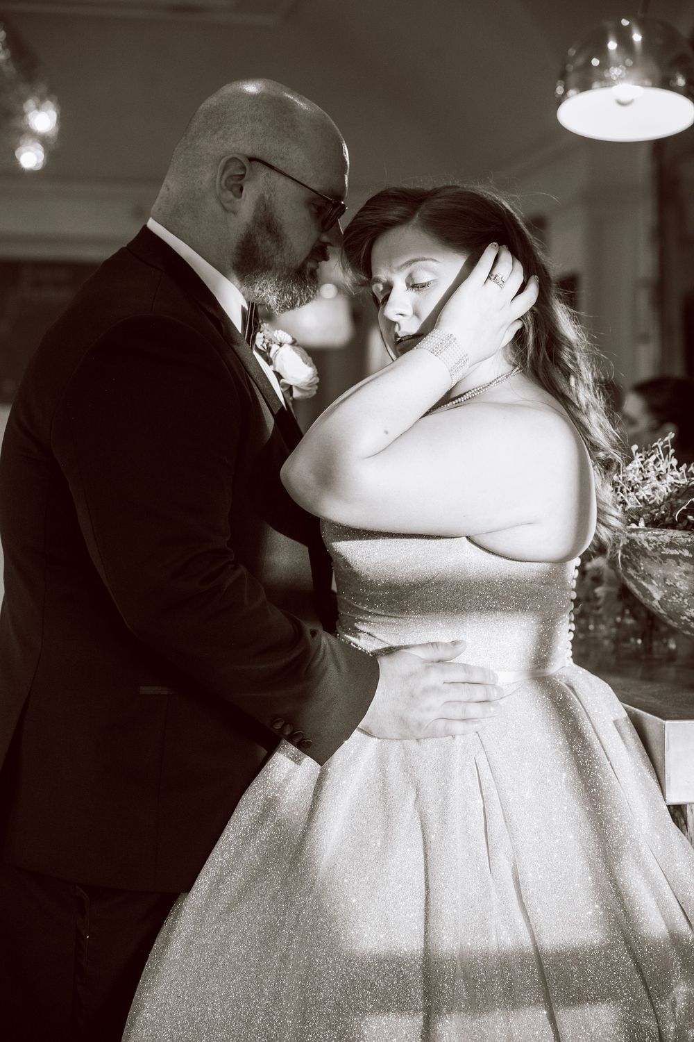 Bride and groom, gorgeous dramatic picture with light shining on the bride, B&W