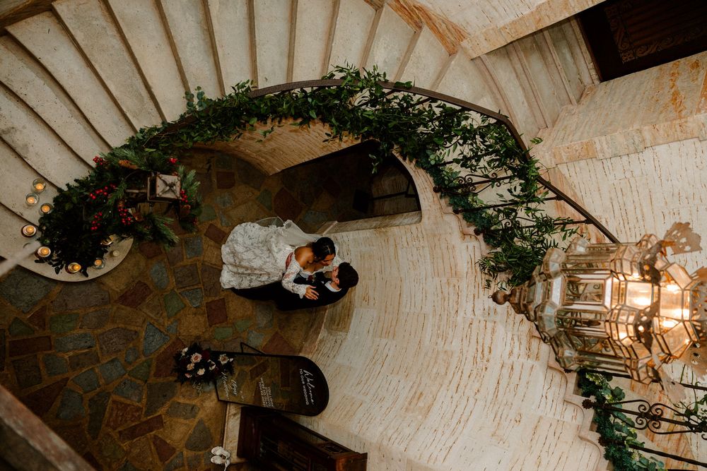 Bride and groom at bottom of staircase at the Howie Mansion in Florida