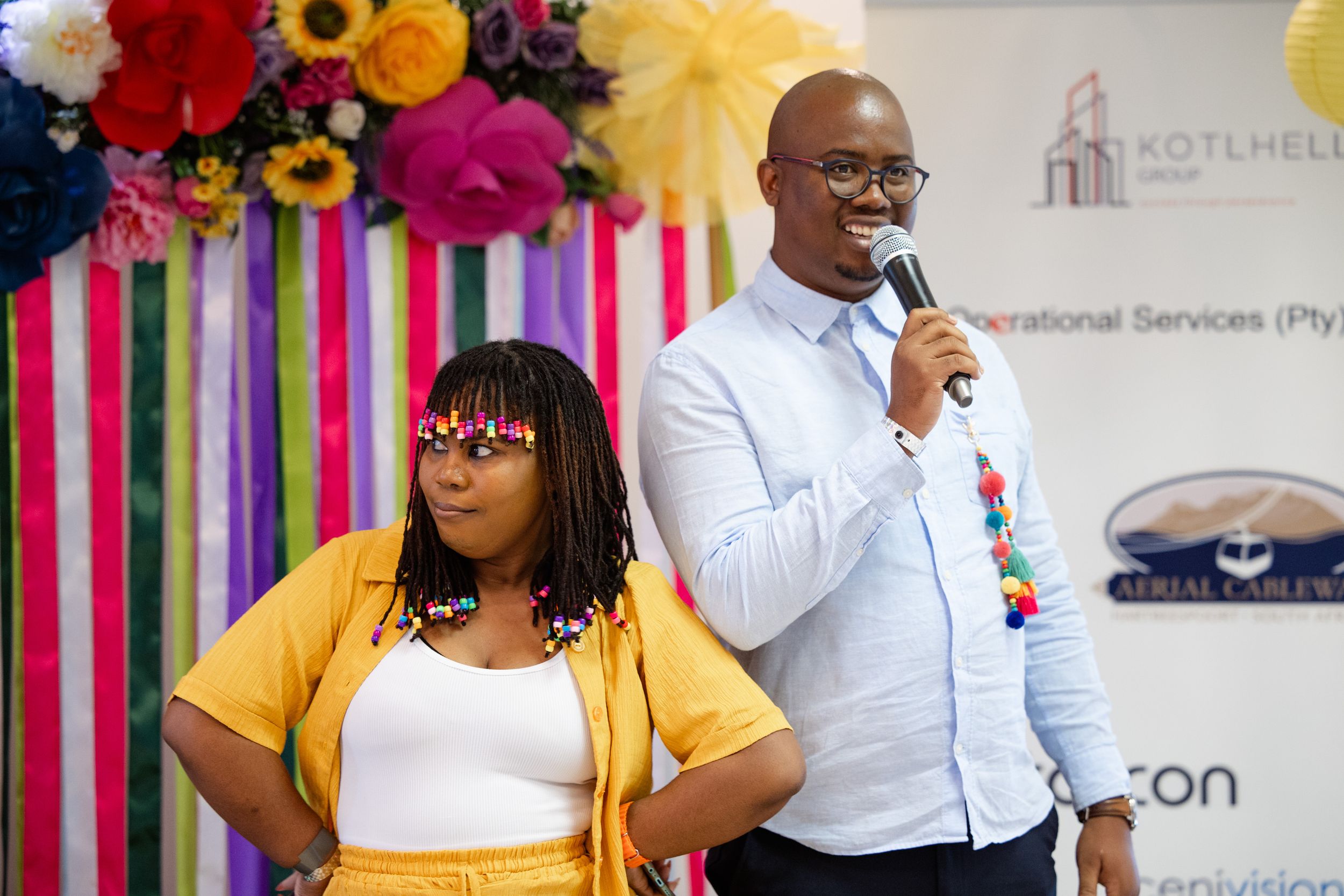 Event hosts speaking to guests during a vibrant corporate awards ceremony.