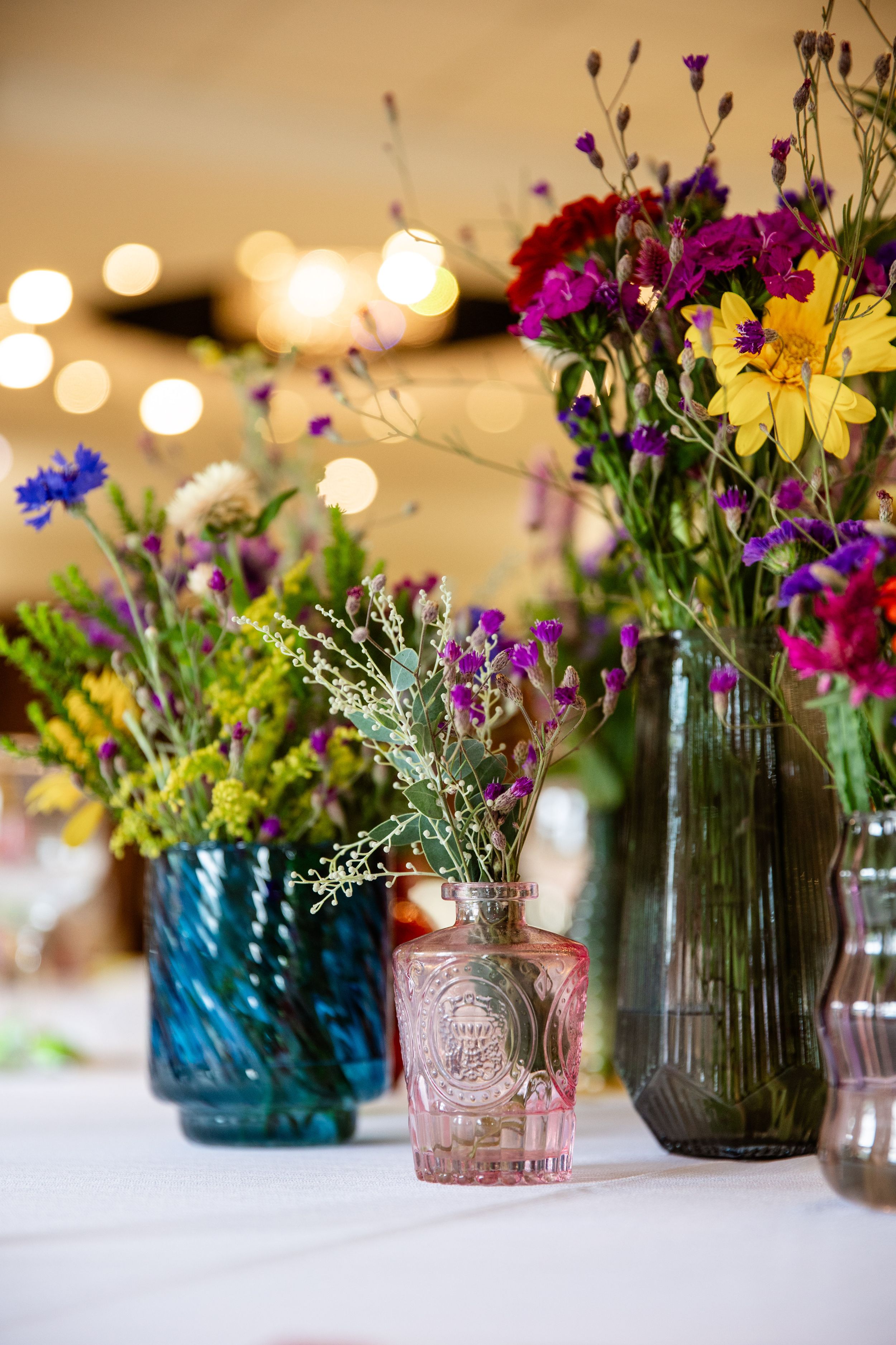 Vibrant floral table arrangements at a professionally photographed awards event.
