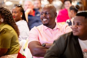 Guests laughing and enjoying themselves during a lively corporate awards event.
