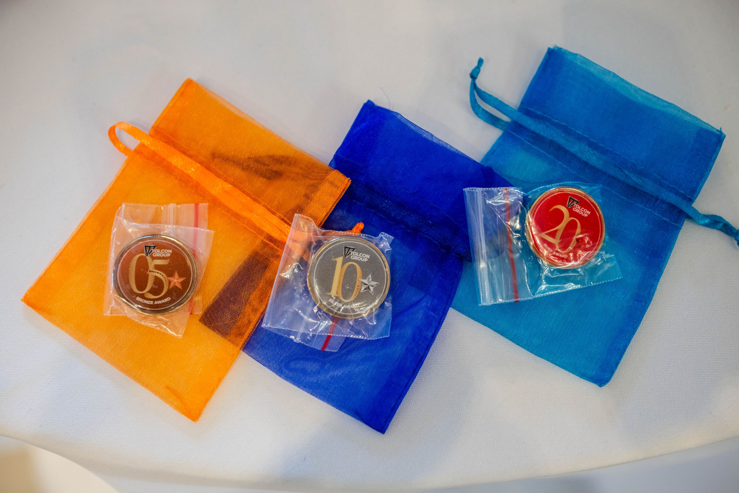 Colourful branded event gifts photographed as part of an awards ceremony.