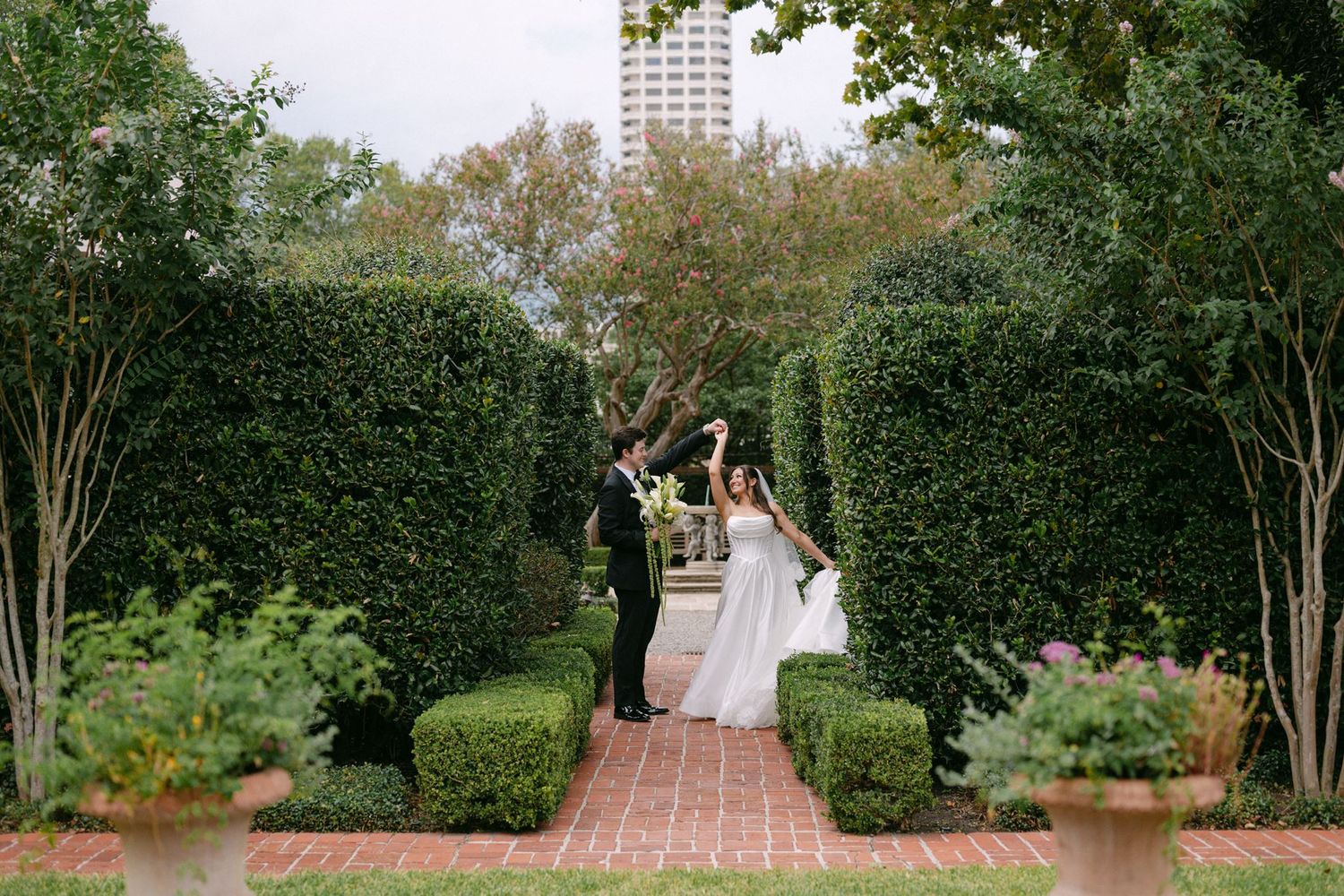 Emma and Sean walking through the gardens at River Oaks Garden Club.