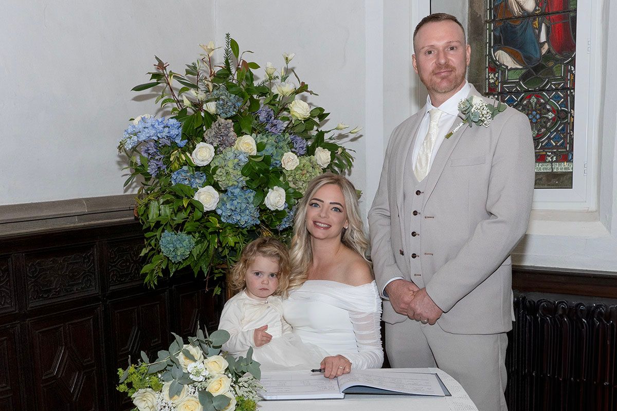 Jamie & Anna's sign the register at their Lake District elopement wedding