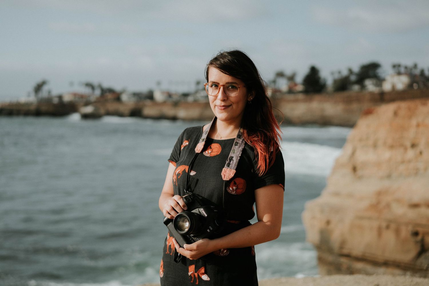 Southern California portrait photographer Kelsey Nevell stands by the ocean in San Diego.