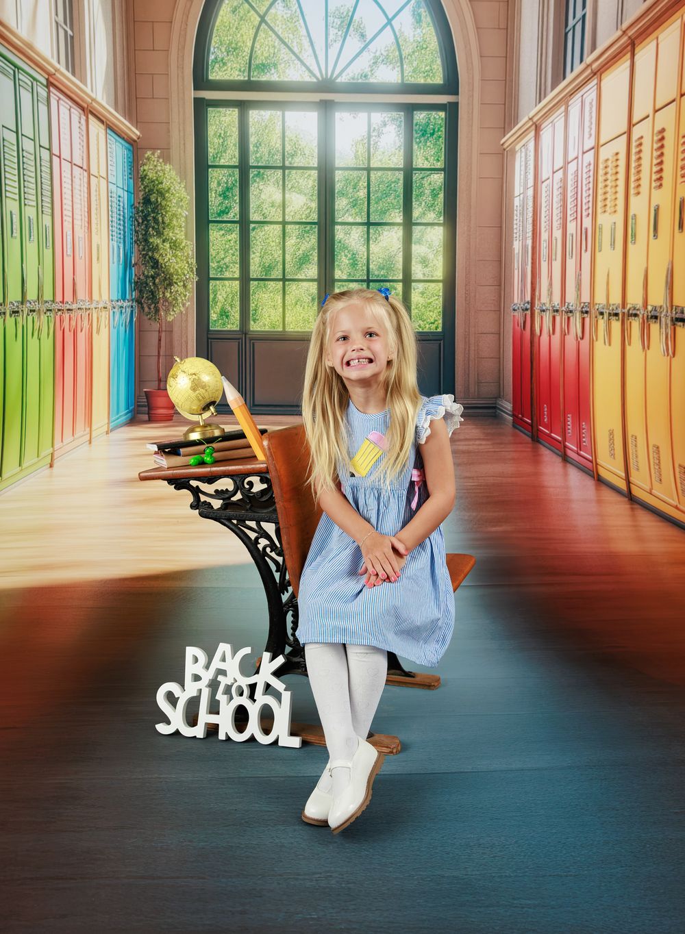 Smiling girl in blue dress sitting at vintage school desk with Back to School sign.