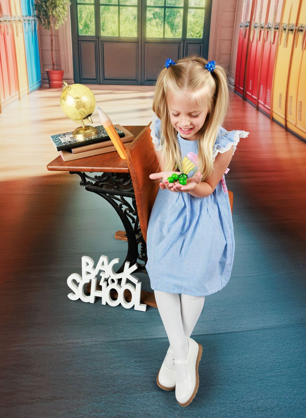 Young girl in blue dress holding toy near school desk with Back to School sign.
