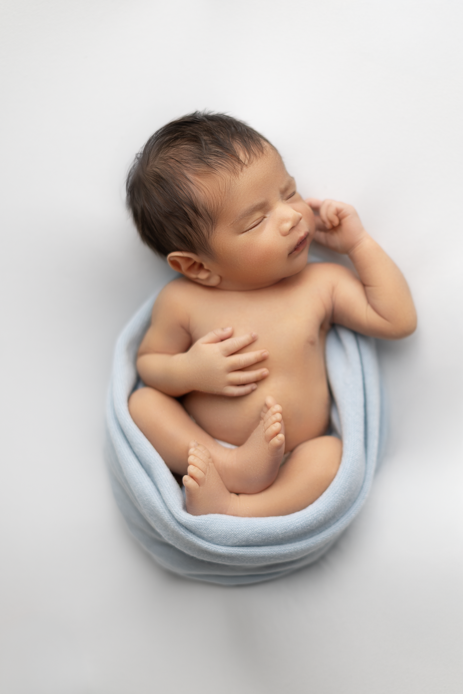 Newborn baby wrapped in a soft blanket during a studio newborn photography session in Ventura County.