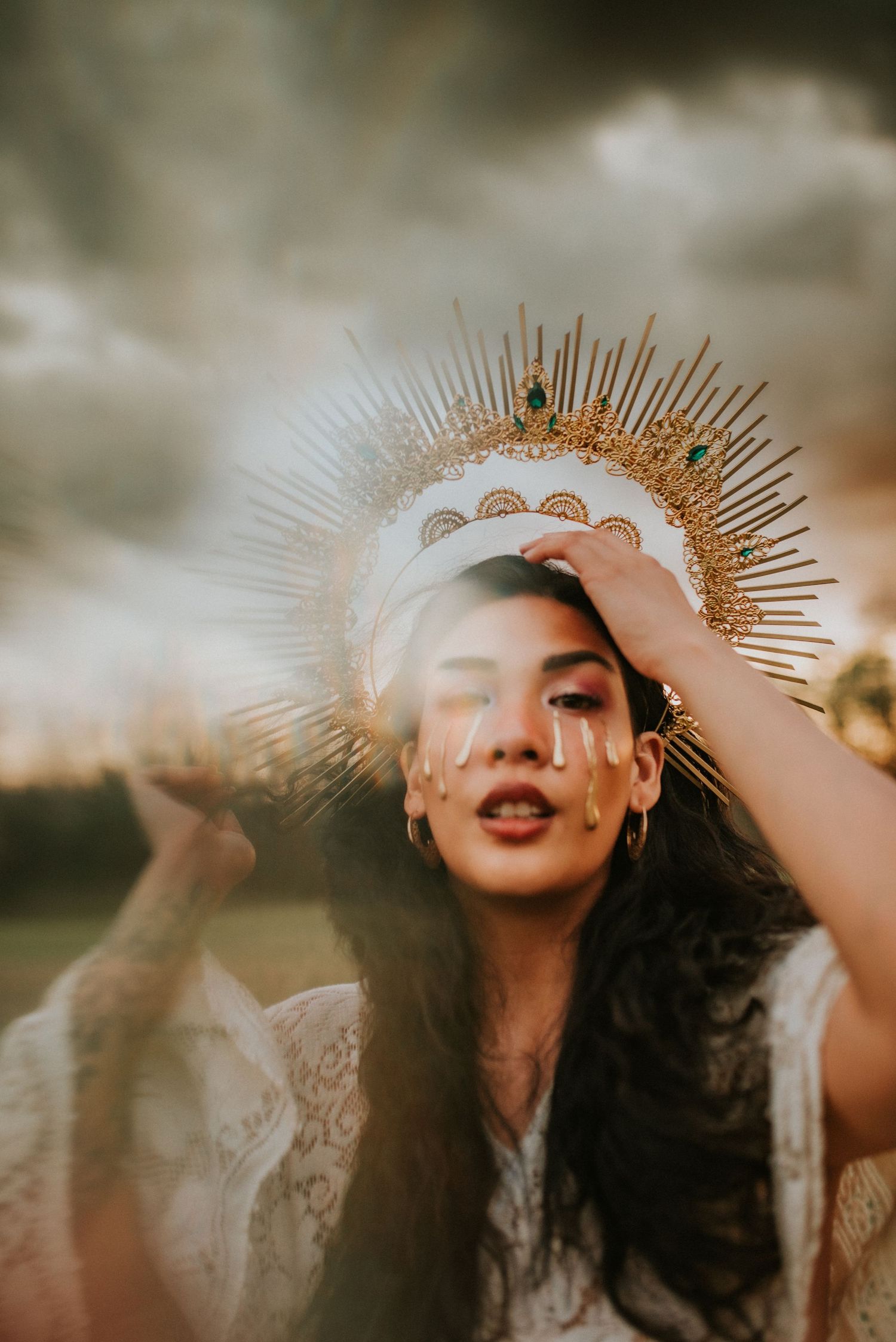 Creative portrait, birthday session, woman with a crown on her head, sunset with dark clouds, golden tears, Clarksville Tennessee, Nashville