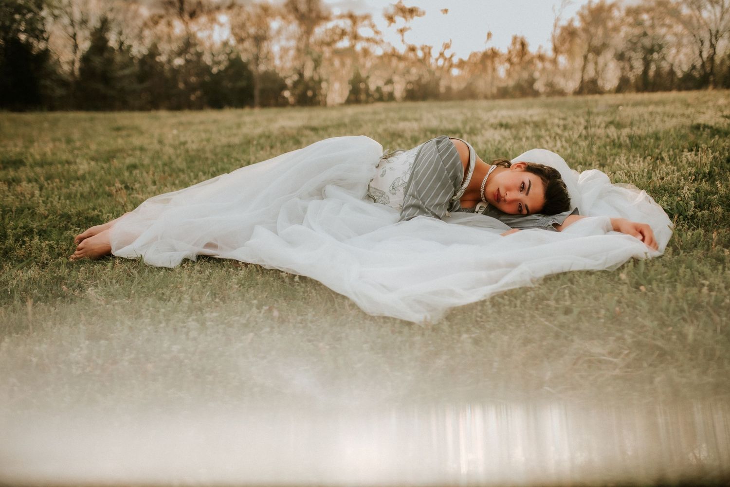 Clarksville Tennessee, Fort Campbell Photographer, Birthday Portraits, Woman laying in field with tulle dress surrounding her, Nashville