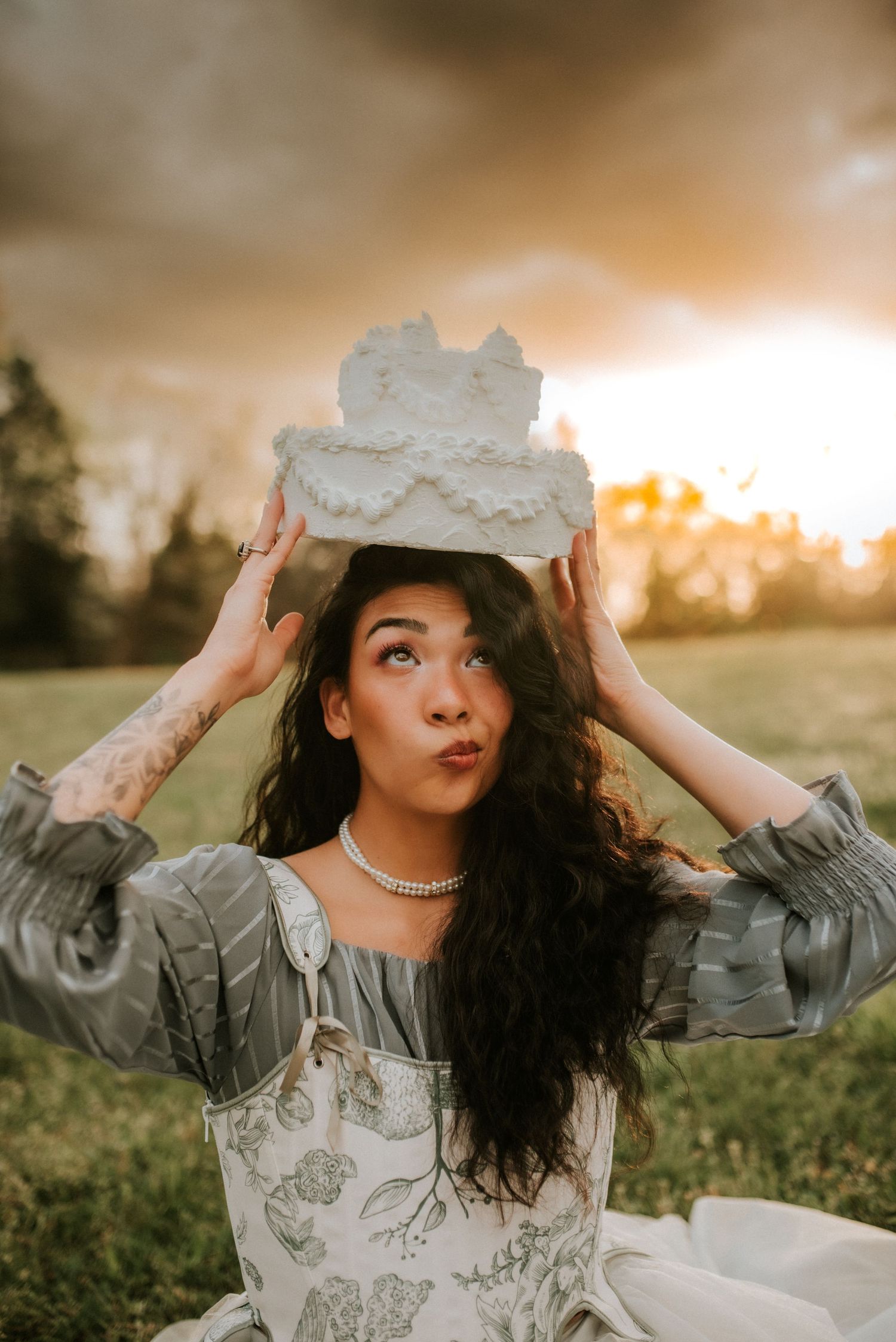 Birthday Portrait of a woman with a cake on her head in Clarksville, Tennessee with a portrait photographer.