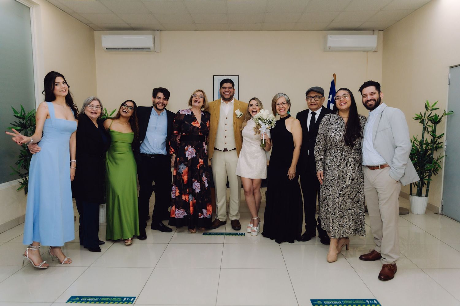 Wedding party group photo with bride and groom after civil ceremony.