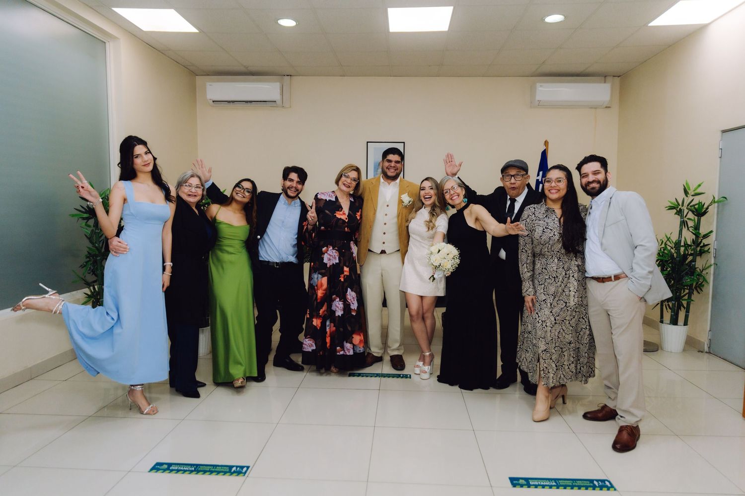 Joyful wedding guests and newlyweds celebrating after civil marriage ceremony.