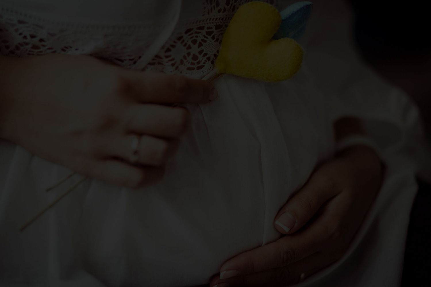 Black and white photo of a sleeping newborn baby wrapped in a soft blanket inside a woven basket.