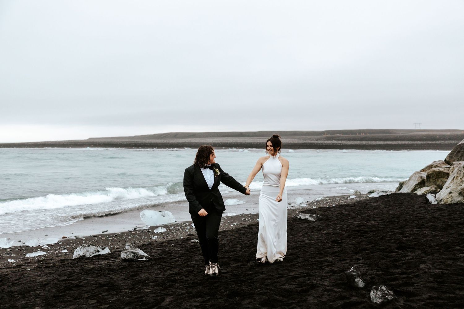 brides walking on the beach at Diamond Beach in Iceland during elopement